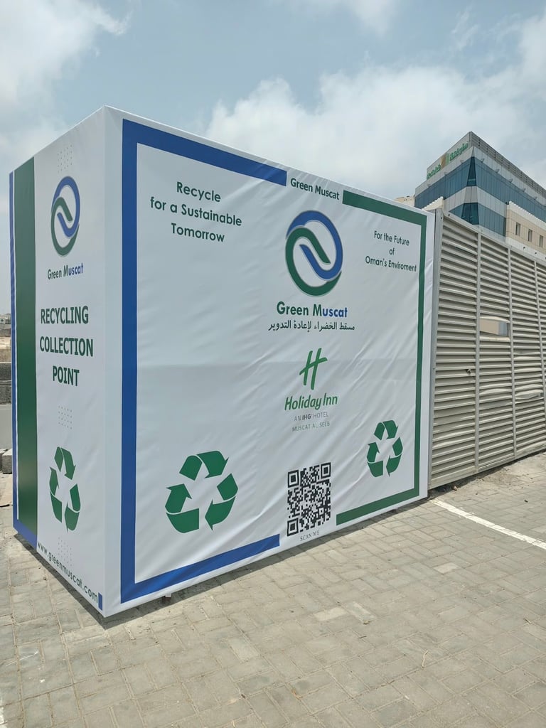 Green Muscat recycling collection point with blue and green branding and recycling symbols on white container