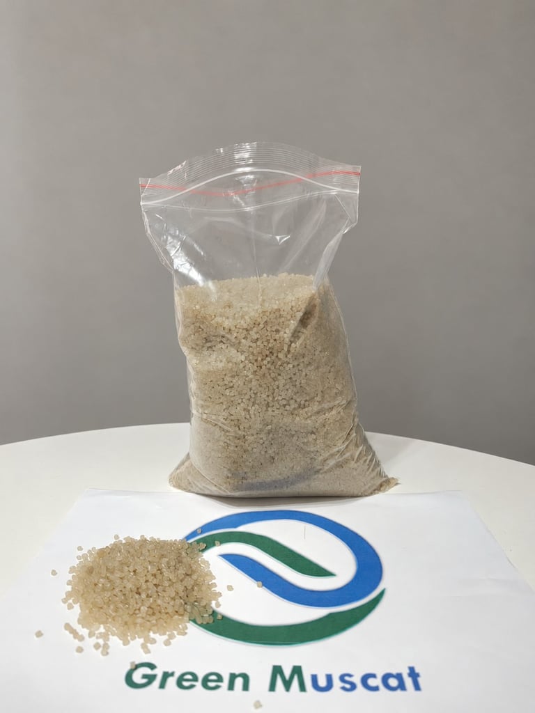 Green Muscat translucent polymer granule sample in a bag