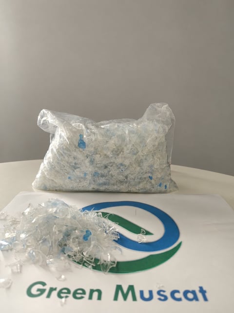 Green Muscat clear plastic flake sample in a bag with loose flakes